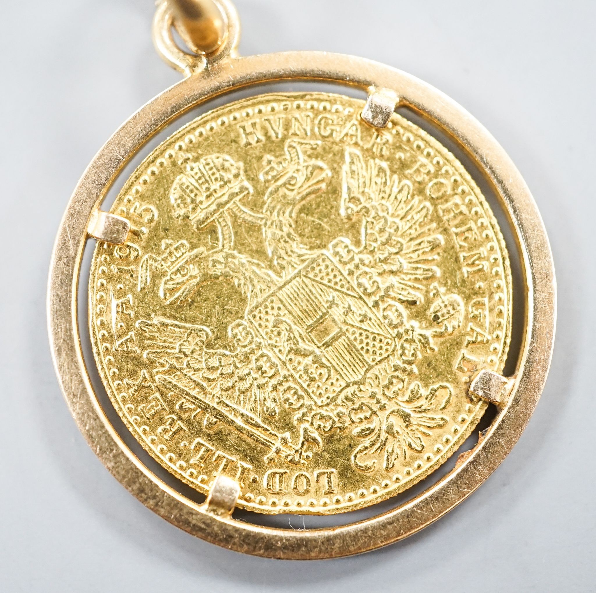 An Austrian 1915 gold ducat re-strike?, on a 750 yellow metal pendant mount, gross 6.2 grams.